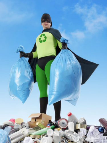 27125205 - eco superhero holding two plastic bags full of domestic trash standing on garbage heap - waste segregation concept